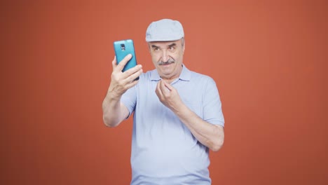 Old-man-making-a-video-call-on-the-phone.